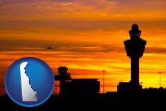 delaware map icon and an airport terminal and control tower at sunset