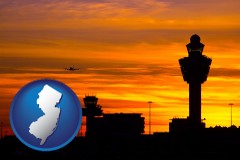 new-jersey map icon and an airport terminal and control tower at sunset