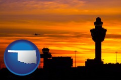 oklahoma map icon and an airport terminal and control tower at sunset