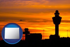 wyoming map icon and an airport terminal and control tower at sunset