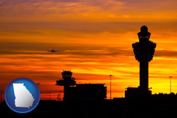 an airport terminal and control tower at sunset - with Georgia icon