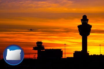 an airport terminal and control tower at sunset - with Oregon icon