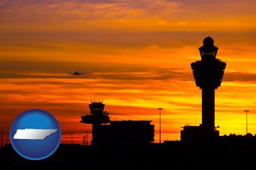 an airport terminal and control tower at sunset - with Tennessee icon